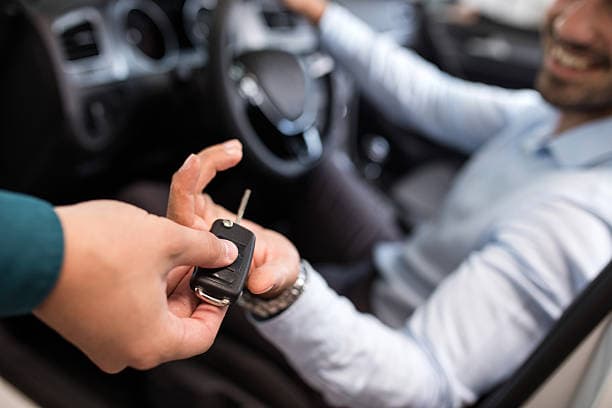Customer receiving keys to their vehicle — straightforward, honest delivery
